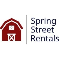 Spring Street Rentals logo featuring a red barn with white door and window